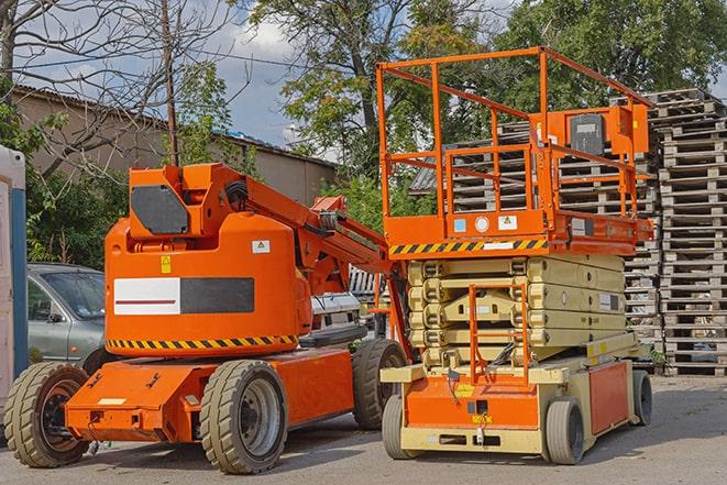 forklift operator transporting heavy loads in a warehouse in Carterville